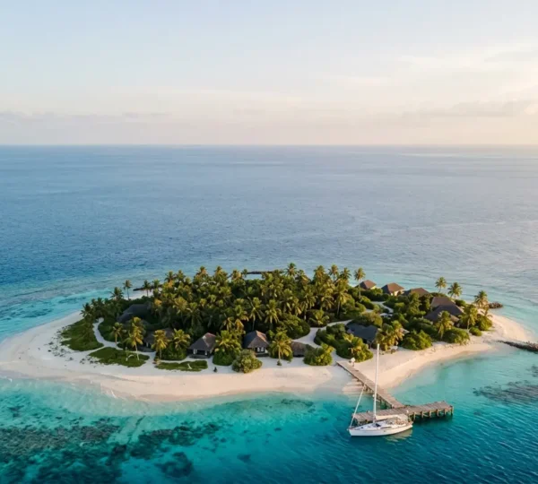 Aerial view of an exclusive private island surrounded by turquoise waters with white sand beaches and lush tropical vegetation