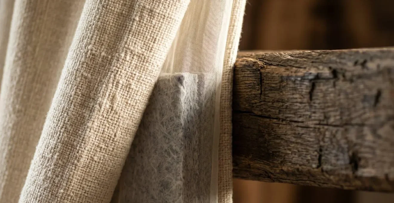 Elegant fabric draping and acoustic panels integrated into rustic barn ceiling to absorb rain noise
