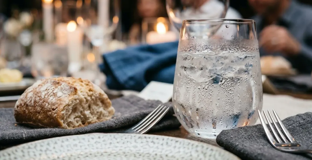 Professionally pre-set wedding reception table with water and bread service