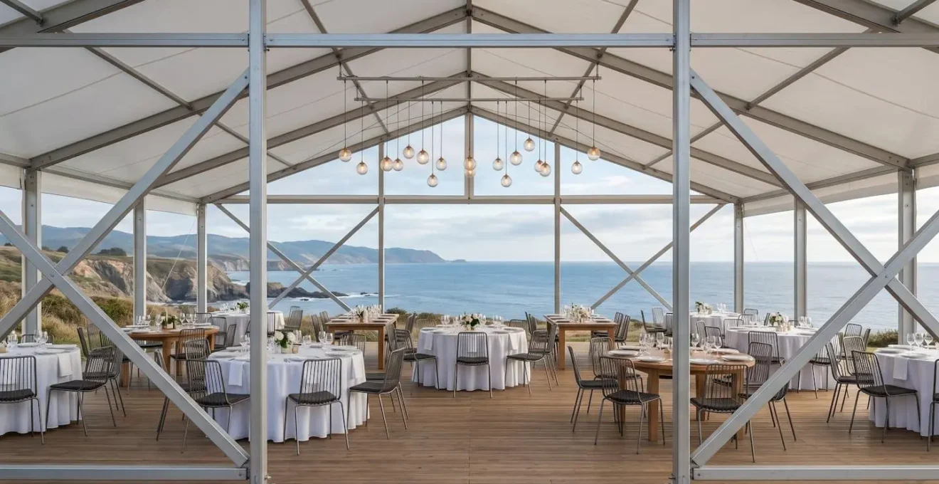 Modern frame tent with clear-span interior at coastal wedding venue showcasing unobstructed layout and geometric design aesthetic