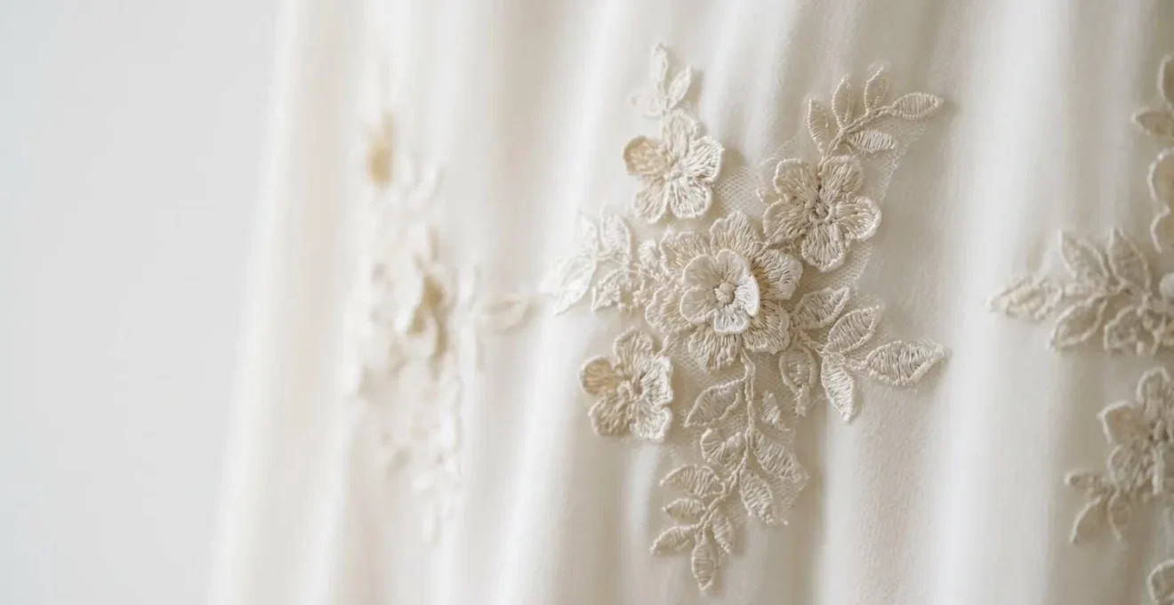 Close-up of delicate three-dimensional floral lace appliques on wedding dress as lightweight alternative to beading