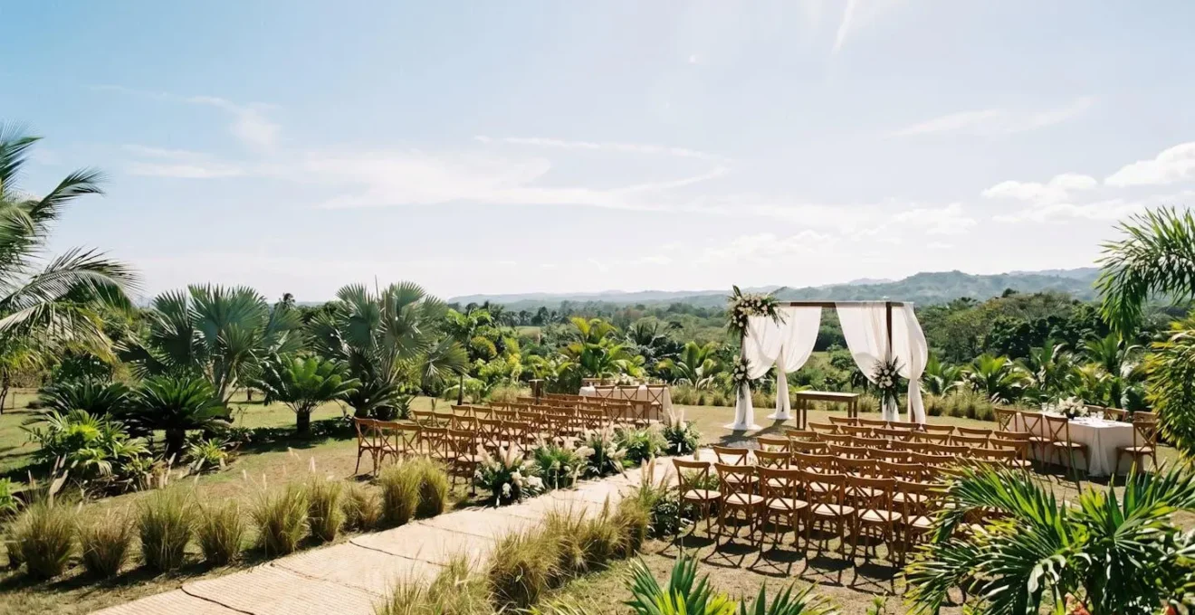Wide environmental shot of tropical outdoor wedding venue showing ambient conditions affecting food stability